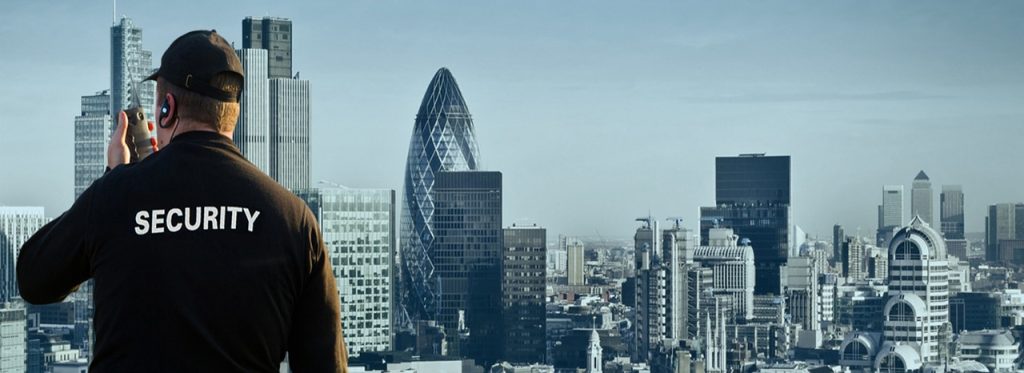 Security officer on a radio overlooking the London skyline