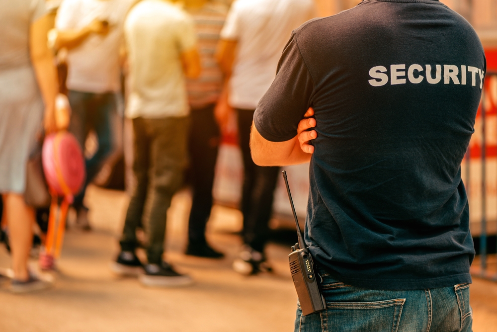 Security officer at an event entrance with visitors