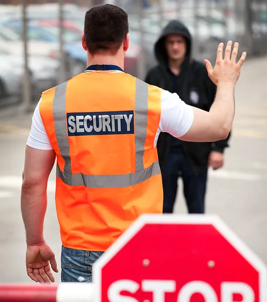 Security officer stopping a person with a raised hand