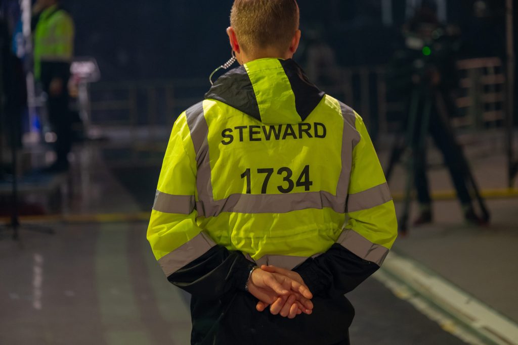 Event steward in hi-vis at night