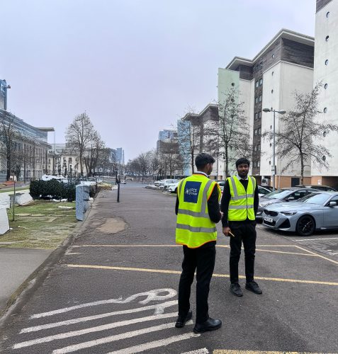 Two FCS Group security officers patrolling a car park by residential blocks