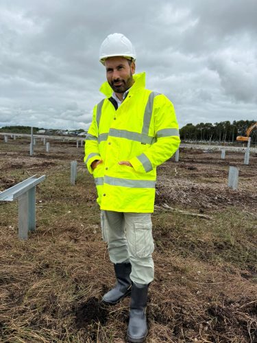 FCS Group labour worker in hi-vis on a solar farm installation site