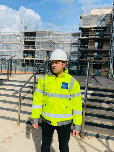FCS Group construction site security officer in hard hat and hi-vis