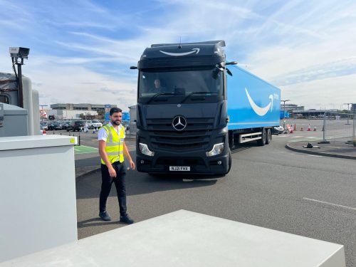 FCS Group lorry park security officer beside an HGV at a distribution yard